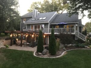 Two-story house with patio and landscaped backyard.